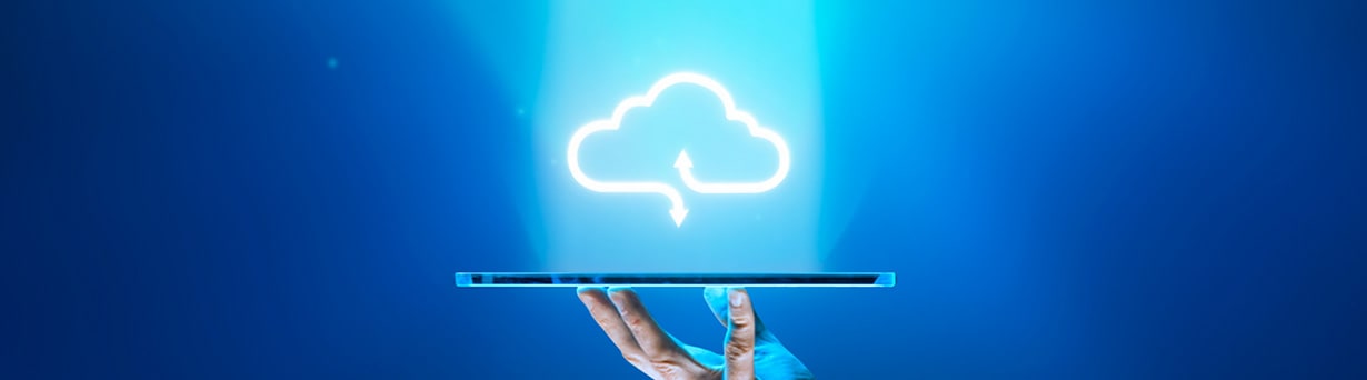 A hand holding a tablet under a cloud icon.