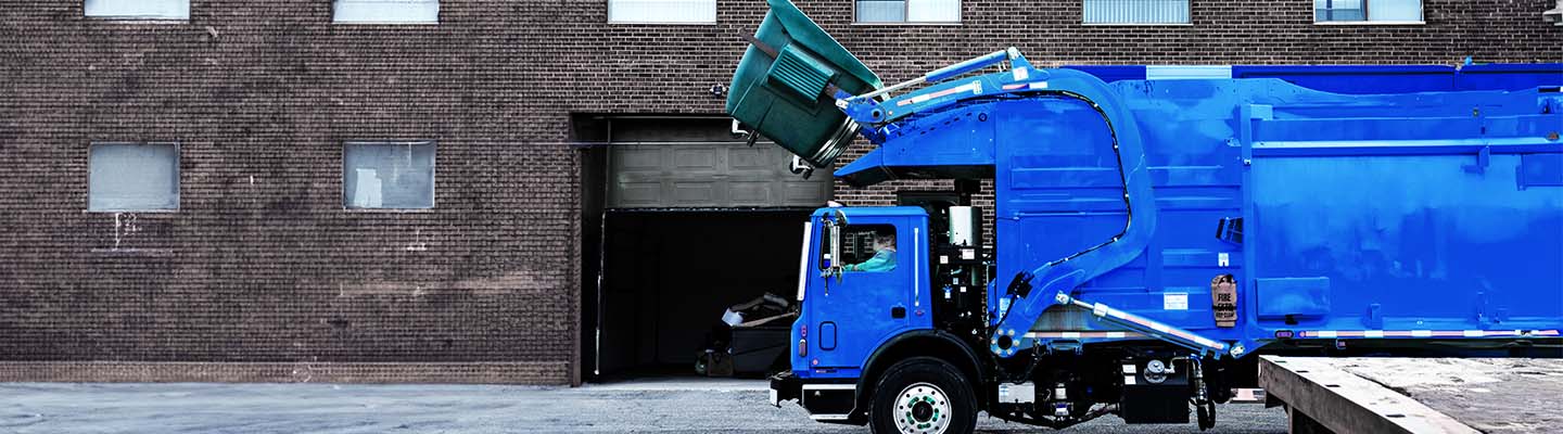 Garbage trucks collecting smart bins that use IoT sensors provided by Bell that can alert managers and help prioritize collections.