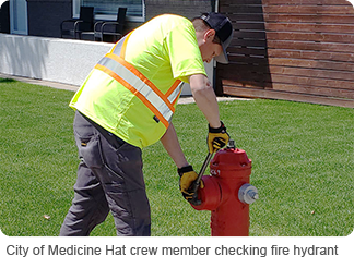 City of Medicine Hat crew member checking fire hydrant