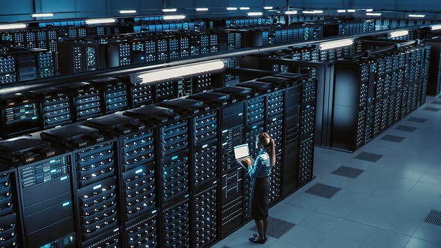 Technician inspecting server racks in a secure data centre